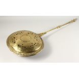 A QUEEN ANN BRASS WARMING PAN with brass handles