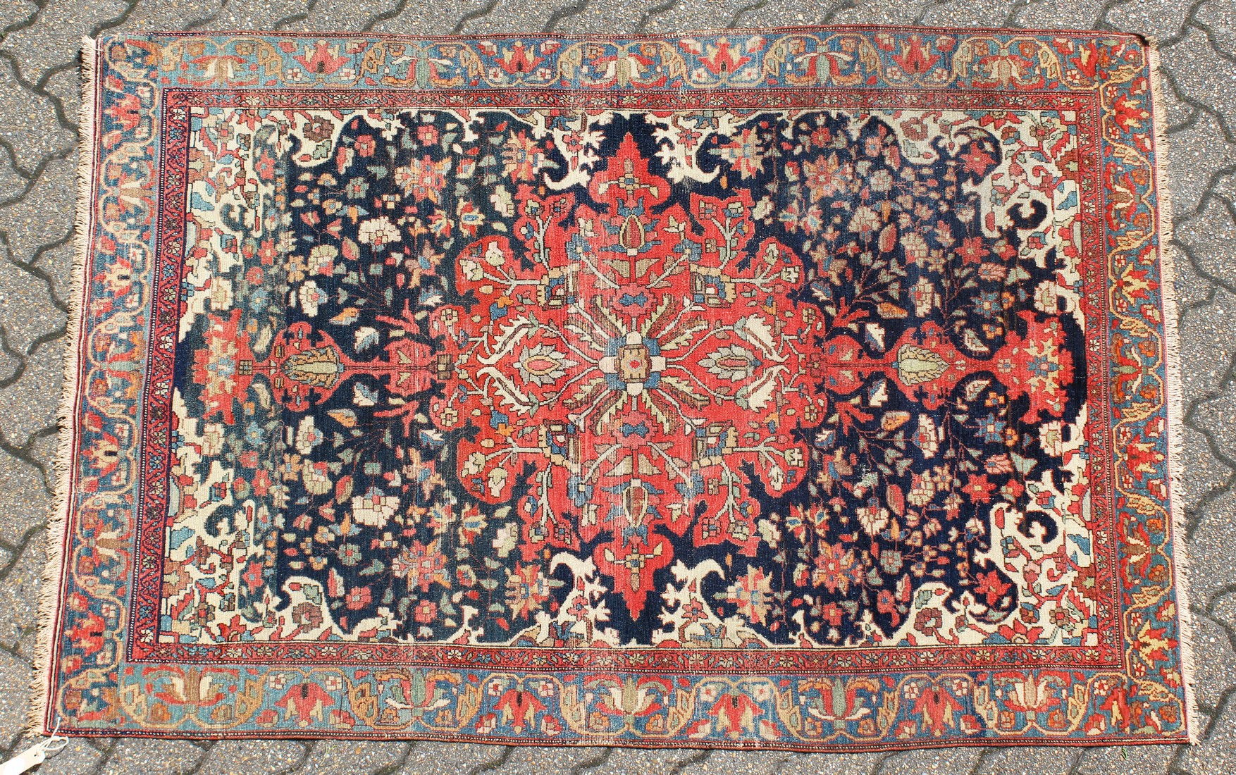 A GOOD MALAYER RUG, red ground with stylised floral decoration within, a pale blue border. 6ft 10ins