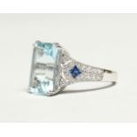 AN 18CT. WHITE GOLD AND AQUAMARINE RING, the rectangular aquamarine approx. 6.3ct, the shoulders set