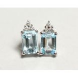 A PAIR OF 18CT WHITE GOLD AQUAMARINE AND DIAMONDS EARRINGS, the rectangular cut aquamarine approx.