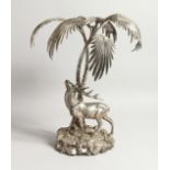A VERY GOOD PLATED CENTREPIECE, a stag standing beneath a palm tree. 17ins high.