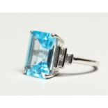 AN IMPRESSIVE 18CT WHITE GOLD, BLUE TOPAZ AND DIAMOND RING, the rectangular cut topaz, approx. 9.
