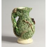 A PALISSY WARE TYPE JUG, with lizard handle and moulded decoration