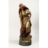 A GOOD LARGE TERRACOTTA FIGURE OF A YOUNG ARAB GIRL carrying a two handled vase, on a circular