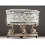 A GOOD ALPACA PLATE OVAL CENTREPIECE with cut glass oval dish on a stand with four dolphin