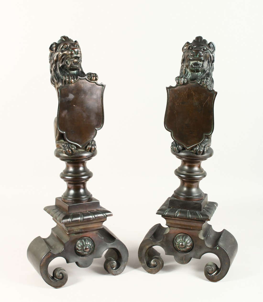 A SUPERB PAIR OF 19TH CENTURY BRONZE LION CHENETS holding a shield 23ins high.