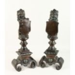 A SUPERB PAIR OF 19TH CENTURY BRONZE LION CHENETS holding a shield 23ins high.