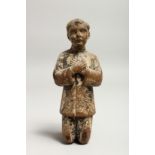 A 17TH CENTURY CARVED WOOD KNEELING FIGURE, praying. 8ins high.