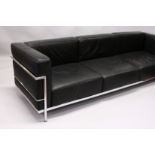 IN THE MANNER OF LE CORBUSTIER, A LARGE CHROME FRAMED THREE SEATS SETTEE, with black leather