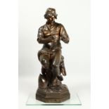 C. MANICLIER. A LARGE BRONZE OF A YOUNG MAN, seated on a tree stump with octagonal base. Signed