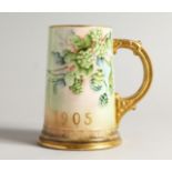 A BEELEEK PORCELAIN TANKARD H. P. C. C. decorated with hops 5.5ins high.