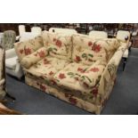 A GOOD MODERN KNOLL LARGE TWO SEATER SETTEE, upholstered in a broad floral print fabric