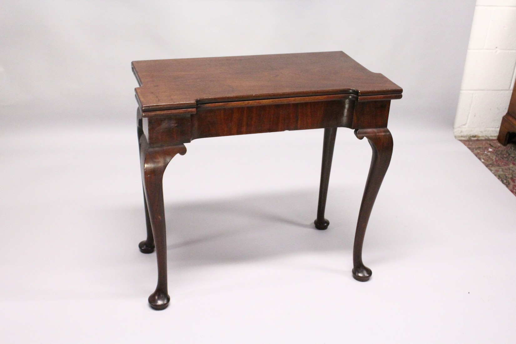 A GEORGE III MAHOGANY FOLD OVER CARD TABLE with a shaped rectangular top, green beize lining with - Image 2 of 5