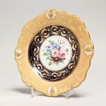 A GOOD COALPORT PLATE, rich gilt border, the centre painted with flowers 8ins diameter.