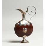 A MINIATURE SILVER MOUNTED EWER, the body formed from a nut or bean. 4ins high