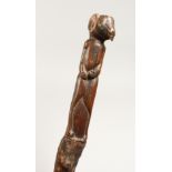 A CARVED FOLK ART STICK 36ins long