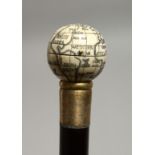 A WALKING STICK WITH A GLOBE COMPASS