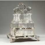 A GOOD GEORGE III FOUR BOTTLE CRUET filled with four whisky decanters and stoppers. The stand with
