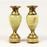 A GOOD SMALL PAIR OF FRENCH CHAMPAGNE ENAMEL AND ONYX VASES. 6.5ins high.