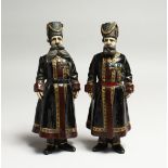 A PAIR OF RUSSIAN BRONZE FIGURES of two men in costume and wearing medals 7ins high