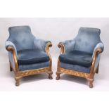 AN IMPOSING PAIR OF PADDED ARM CHAIRS with blue velvet covers and show wood forms. The curving