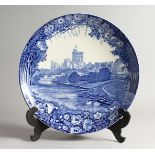 WOOD AND SONS, WINDSOR. A BLUE AND WHITE CHARGER decorated with a scene of Windsor Castle from the