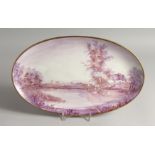 A PORCELAIN OVAL PLAQUE, painted with cattle and a man by a pond. Signed. 16.5 ins wide.
