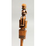 A CARVED WOOD TRIBAL HAIR PIN with figural top. 8.5ins long