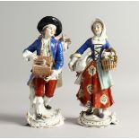 A PAIR OF SAMSON CHELSEA DERRY PORCELAIN FIGURES, a man with a rabbit in a box, a girl carrying a