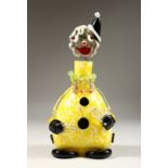 A MERANO MOTTLED YELLOW CLOWN BOTTLE AND STOPPER. 12ins high.