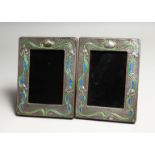 A PAIR OF SILVER AND ENAMEL PHOTOGRAPH FRAMES 7.5ins x 5.5ins