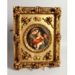 A GOOD GERMAN PORCELAIN CIRCULAR PLAQUE, Madonna and child 5.5ins diameter in a gilded frame.