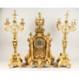 A LARGE FRENCH ORMOLU THREE PIECE CLOCK GARNITURE, the clock with urn finial, garlands, lion masks