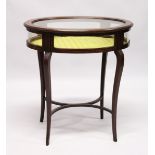 A GOOD EDWARDIAN MAHOGANY OVAL BIJOUTERIE TABLE with rising glass top , glass sides on curving