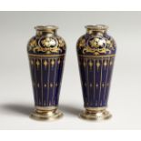 A GOOD PAIR OF LIMOGES BLUE AND GILT PORCELAIN VASES with sliver tops and bases. 4.25ins high.