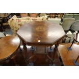 AN EDWARDIAN INLAID ROSEWOOOD OCTAGONAL TOP CENTRE TABLE with tapering legs and porcelain castors.