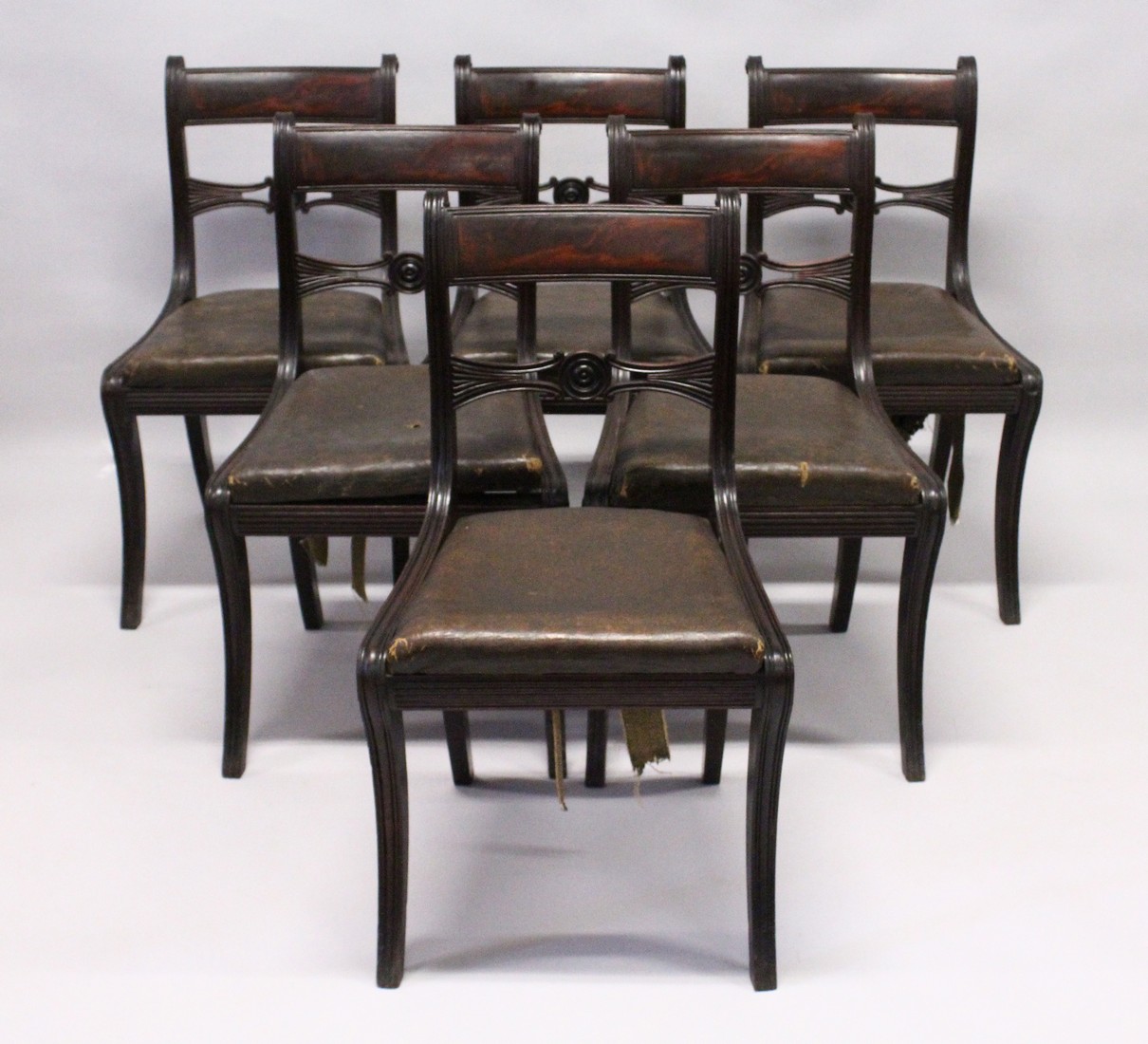 A GOOD SET OF SIX REGENCY MAHOGANY DINING CHAIRS, reeded frames, sabre legs and drop in seats