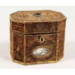 A GEORGE III ROLLED PAPER OCTAGONAL TEA CADDY inlaid with an oval. 5.5ins long.