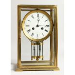 A GOOD BRASS FOUR GLASS CLOCK with white dial and pendulum. 12ins high.