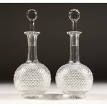 A GOOD PAIR OF HOBNAIL CUT PORT DECANTERS AND STOPPERS. 10.5ins high.