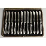 A SET OF 12 SILVER HANDLED CASED FRUIT KNIVEs.