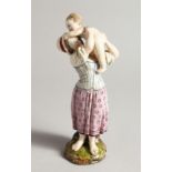 A 19TH CENTURY HORCH POTTERY GROUP, MOTHER AND CHILD, on a rustic base. Wheel mark 8.5ins high.