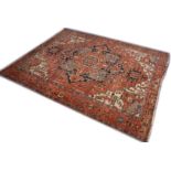 A GOOD LARGE PERSIAN HERIZ CARPET, red ground with central medallion and stylised decoration. 13ft