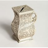 A RARE CONTINENTAL SILVER MONEY BOX decorated with scrolls and cupids with floral carrying handle.