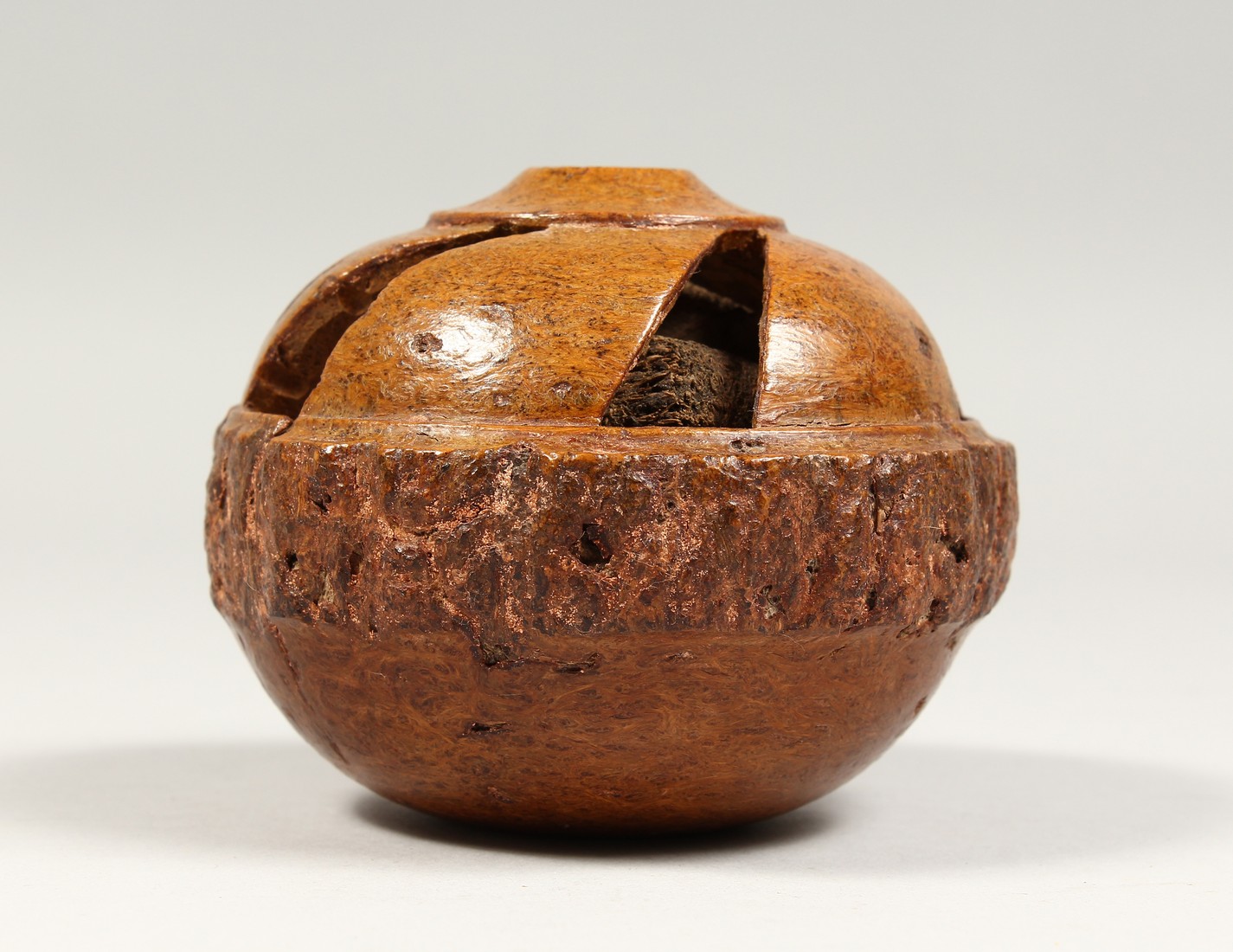 A TREEN BRAZIL NUT, carved and pierced, Desborough Collection. 4ins diameter