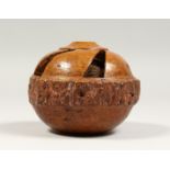 A TREEN BRAZIL NUT, carved and pierced, Desborough Collection. 4ins diameter