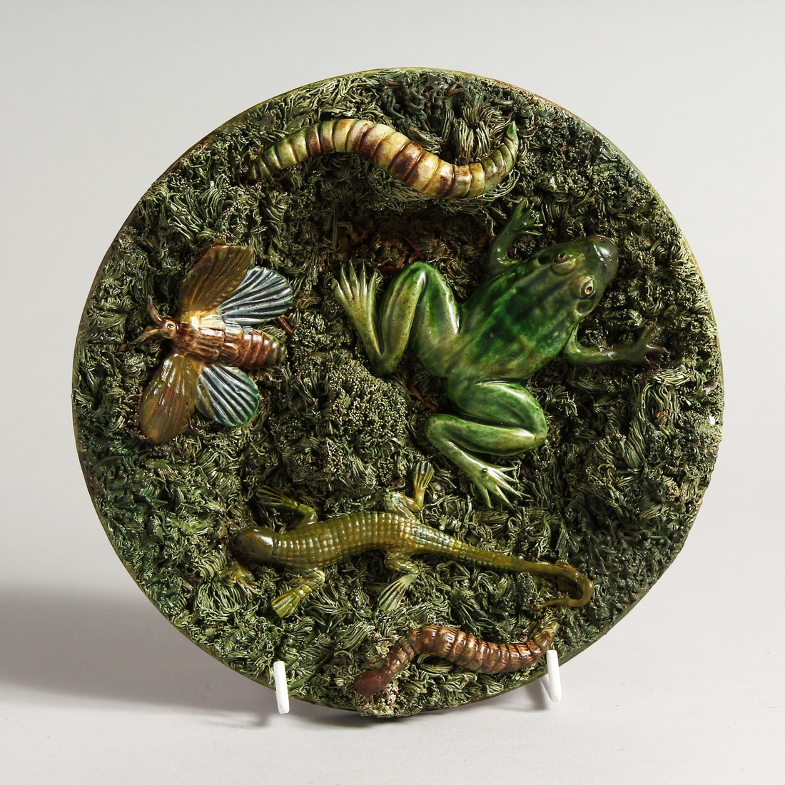 A PALISSY WARE TYPE CIRCULAR DISH, moulded decoration with a frog, lizard etc., impressed mark to