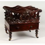 A 19TH CENTURY ROSEWOOD THREE-DIVISION CANTERBURY, with turned end, a single drawer, on turned