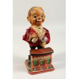 A TIN PLATE TOY BARTENDER 12ins high.