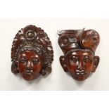 A PAIR OF EARLY CARVED HARDWOOD MASKS